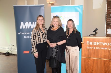 L-R Taryn Faliszewski presents Stephanie Clarke, Jennifer Montgomery of Blue Door Group with the Women of the Year Award for 2021